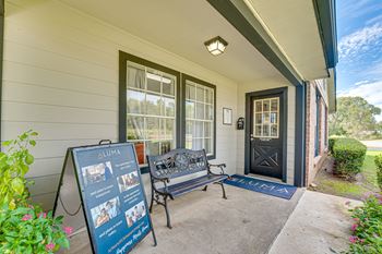 Covered front porch with bench and welcome mat
